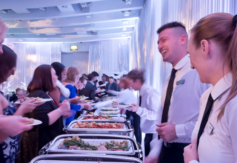 Staff serving the Christmas Menu in the Great Hall