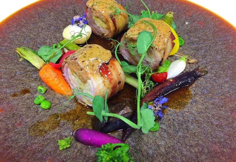 Stuffed and pancetta wrapped rabbit saddle, summer garden peas, pea puree, liquorice liver napage